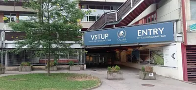 a building with a sign for the entry to a store at B&B Chuchle Arena Praha in Prague