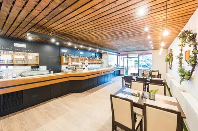 a restaurant with a bar with tables and chairs at B&B Chuchle Arena Praha in Prague