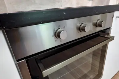 a stainless steel oven with a black counter top at Residence Port Karolina in Prague