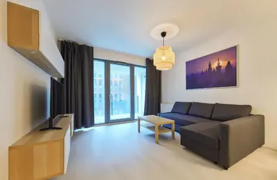 a living room with a couch and a tv at Residence Port Karolina in Prague