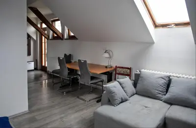 a living room with a couch and a table at V sadu in Lysá nad Labem