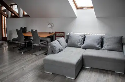 a living room with a couch and a table at V sadu in Lysá nad Labem