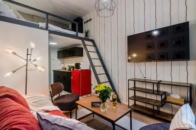 a living room with a couch and a red refrigerator at Royal Apartments Prague by Michal&Friends in Prague