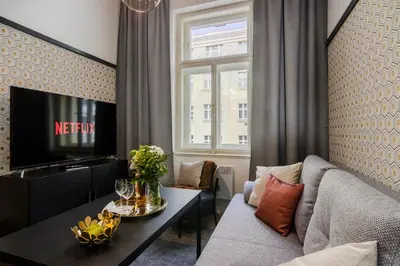 a living room with a couch and a tv at Royal Apartments Prague by Michal&Friends in Prague