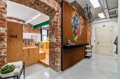a room with a brick wall and a door with a painting at Royal Apartments Prague by Michal&Friends in Prague