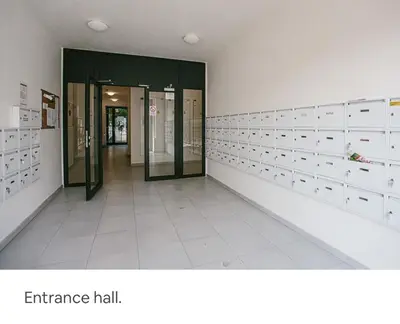 an entrance hall of a building with glass doors at Modern Studio in Prague 7 in Prague