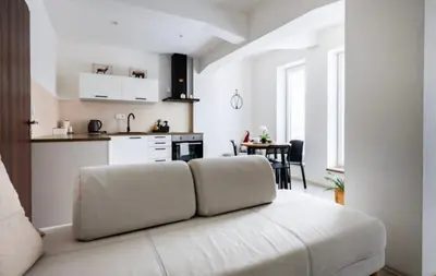 a living room with a couch and a kitchen at Modern Studio in Prague 7 in Prague