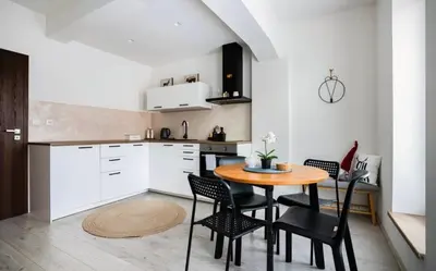 a kitchen with a table and chairs in a room at Modern Studio in Prague 7 in Prague