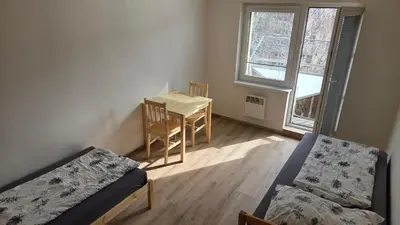 a room with a table and a chair and a table and a table and chairs at Apartmán Mírová 472 B in Milovice