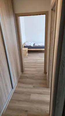 a hallway with a view of a room with a bed at Apartmán Mírová 472 B in Milovice