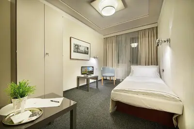 a hotel room with a bed and a desk at Hotel Kladno in Kladno