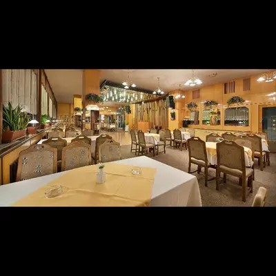 a dining room with tables and chairs and a restaurant at Hotel Kladno in Kladno