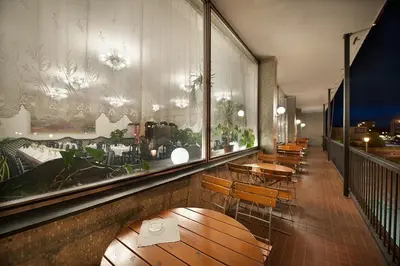 a row of tables and chairs in a restaurant at Hotel Kladno in Kladno