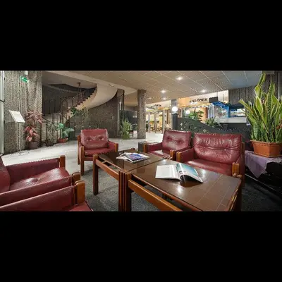 a living room with leather chairs and a table at Hotel Kladno in Kladno