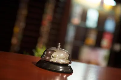 a bell sitting on top of a wooden table at Hotel Kladno in Kladno