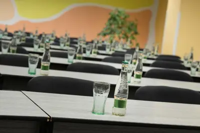 a row of tables with empty bottles on them at Hotel Kladno in Kladno