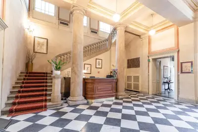a large hallway with a staircase in a building at Vila Lanna in Prague