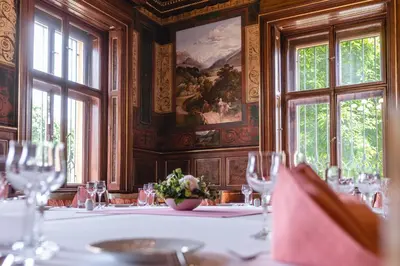 a dining room with a table with wine glasses at Vila Lanna in Prague