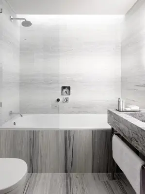 a bathroom with a bath tub and a sink at The Emblem Prague Hotel in Prague
