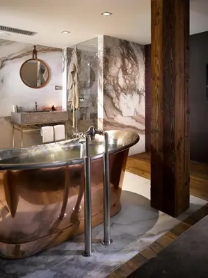 a bathroom with a tub and a sink at The Emblem Prague Hotel in Prague