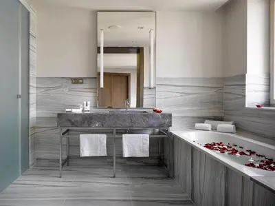 a bathroom with a sink and a bath tub at The Emblem Prague Hotel in Prague