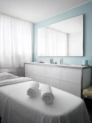 a bathroom with a bed with two towels on it at The Emblem Prague Hotel in Prague