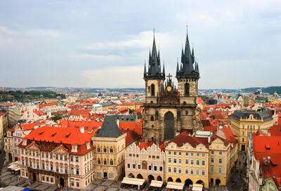 an old building with a clock tower in a city at The Emblem Prague Hotel in Prague