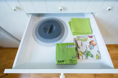 a white washing machine with green towels on a shelf at Modern apartment Spanelska in Prague