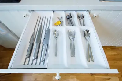 a white tray with utensils on a shelf at Modern apartment Spanelska in Prague