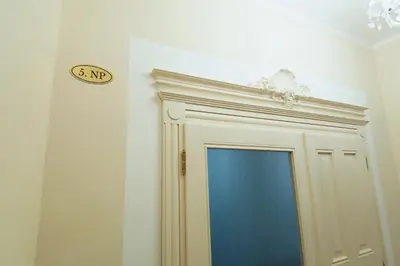 a bathroom with a door with a sign on the wall at Modern apartment Spanelska in Prague