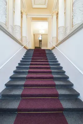 a staircase in a building with purple carpet at Modern apartment Spanelska in Prague