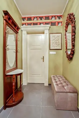 a room with a door and a stool and a mirror at Newly opened, designer OPERA Apartment in Prague