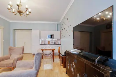 a living room with a large flat screen tv at Newly opened, designer OPERA Apartment in Prague
