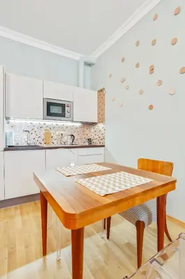 a kitchen with a wooden table in a room at Newly opened, designer OPERA Apartment in Prague