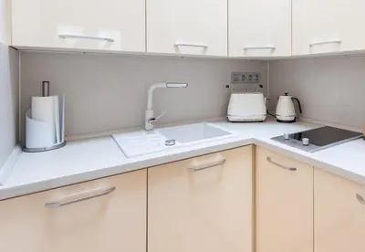 a kitchen with white cabinets and a sink at COZY&QUIET apartment with A/C in city centre in Prague