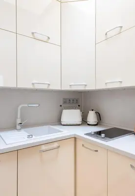 a kitchen with white cabinets and a sink at COZY&QUIET apartment with A/C in city centre in Prague