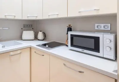 a kitchen with a microwave on a counter at COZY&QUIET apartment with A/C in city centre in Prague