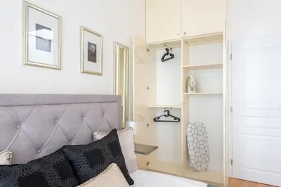 a bedroom with a bed with a gray headboard at COZY&QUIET apartment with A/C in city centre in Prague