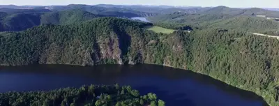 an aerial view of a lake in the middle of a forest at Apartmá u Hovorků in Županovice