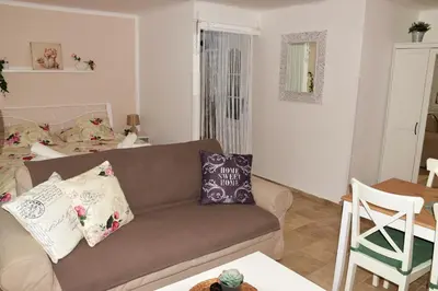 a living room with a couch and a table at Studio Boroví in Karlštejn