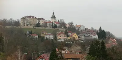 a town on top of a hill with a building at Ubytování Na Vyhlídce 143 in Benátky nad Jizerou