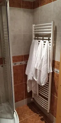 a group of white towels hanging on a rack in a bathroom at Ubytování Na Vyhlídce 143 in Benátky nad Jizerou