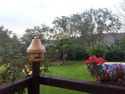 a bird feeder on a fence with a garden at Villa Blanka in Horní Podkozí