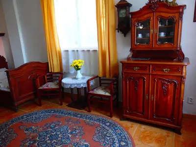a room with wooden furniture and a table and chairs at Villa Blanka in Horní Podkozí