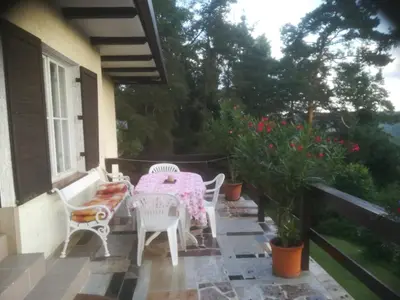 a patio with a table and chairs on a balcony at Villa Blanka in Horní Podkozí