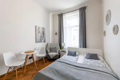a bedroom with two beds and a table and chairs at Awesome Stay Studios in Prague