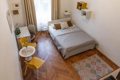 a small room with a bed and a table and chairs at Awesome Stay Studios in Prague