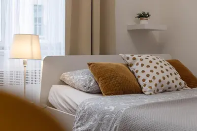 a white couch with pillows and a lamp in a room at Awesome Stay Studios in Prague