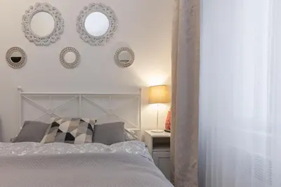 a bedroom with a bed and mirrors on the wall at Awesome Stay Studios in Prague