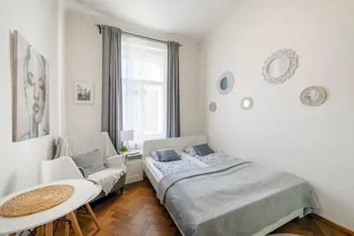 a bedroom with a bed and a chair and a table at Awesome Stay Studios in Prague